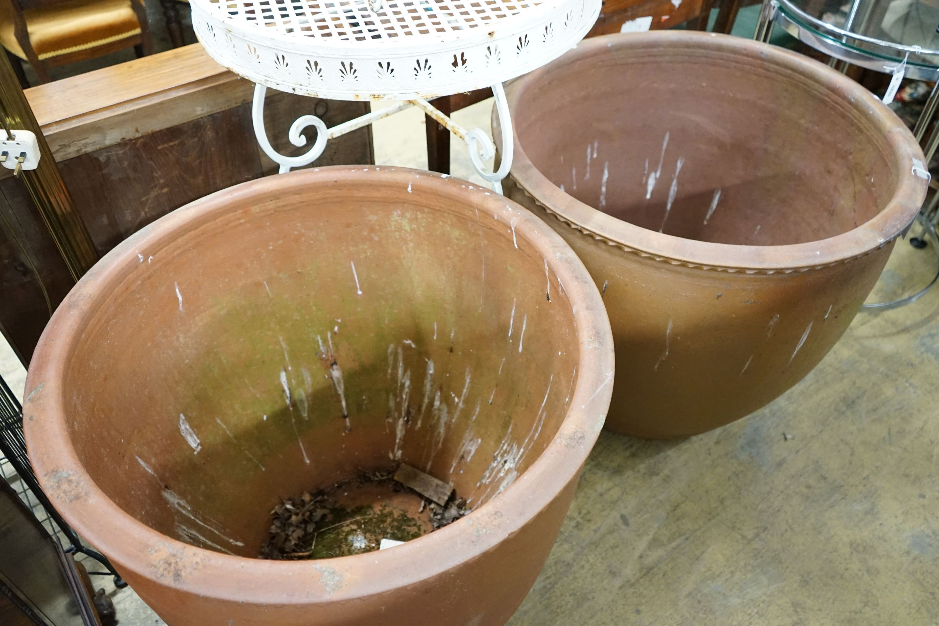 A pair of large circular terracotta planters, diameter 79cm, height 69cm